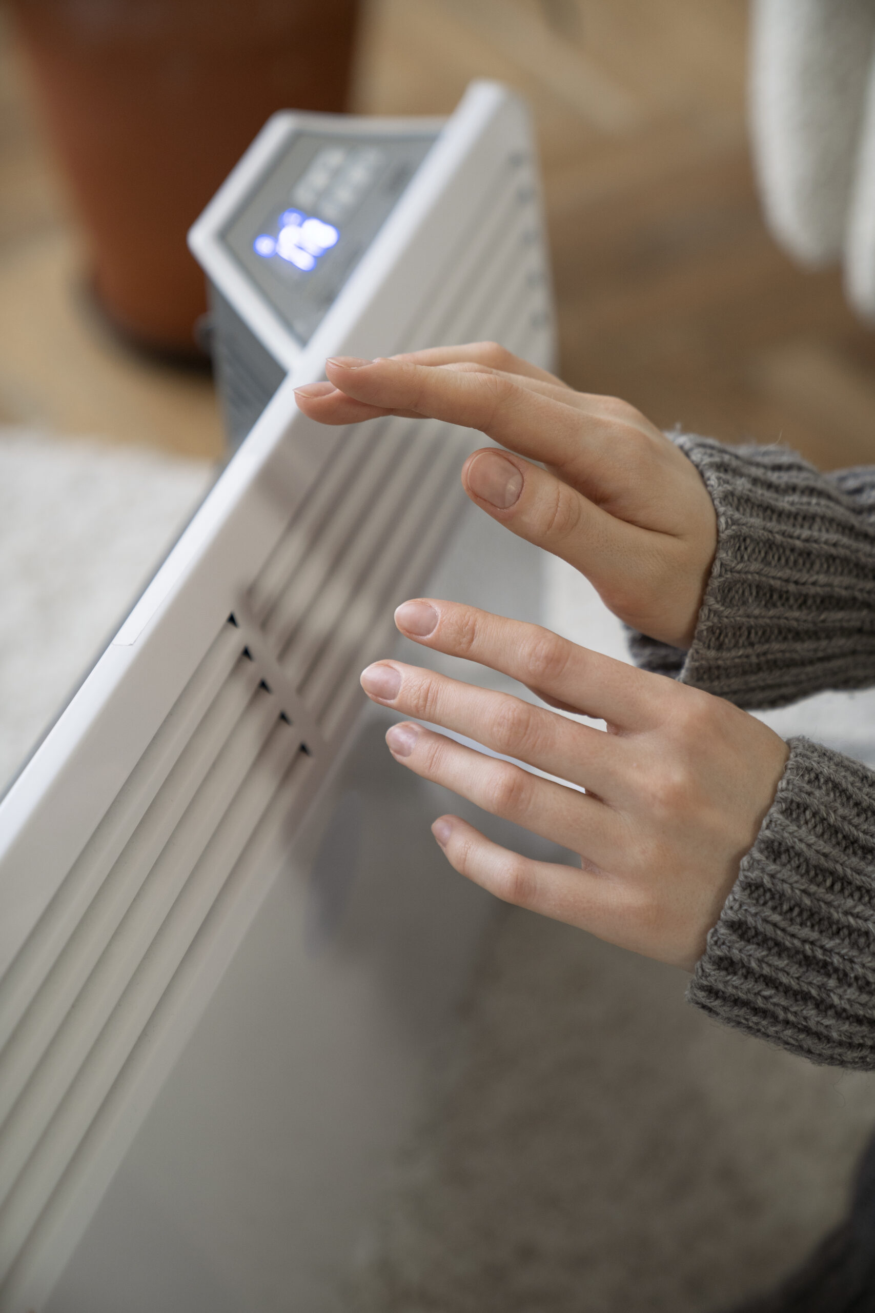 close-up-person-near-heater
